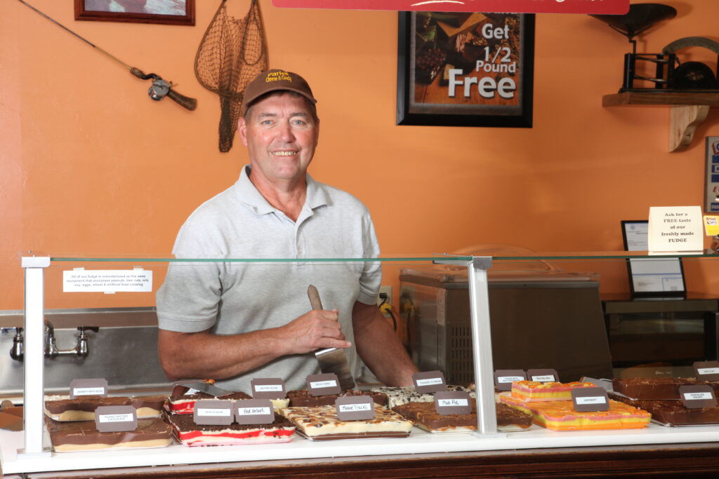Fudge retailer working behind the counter
