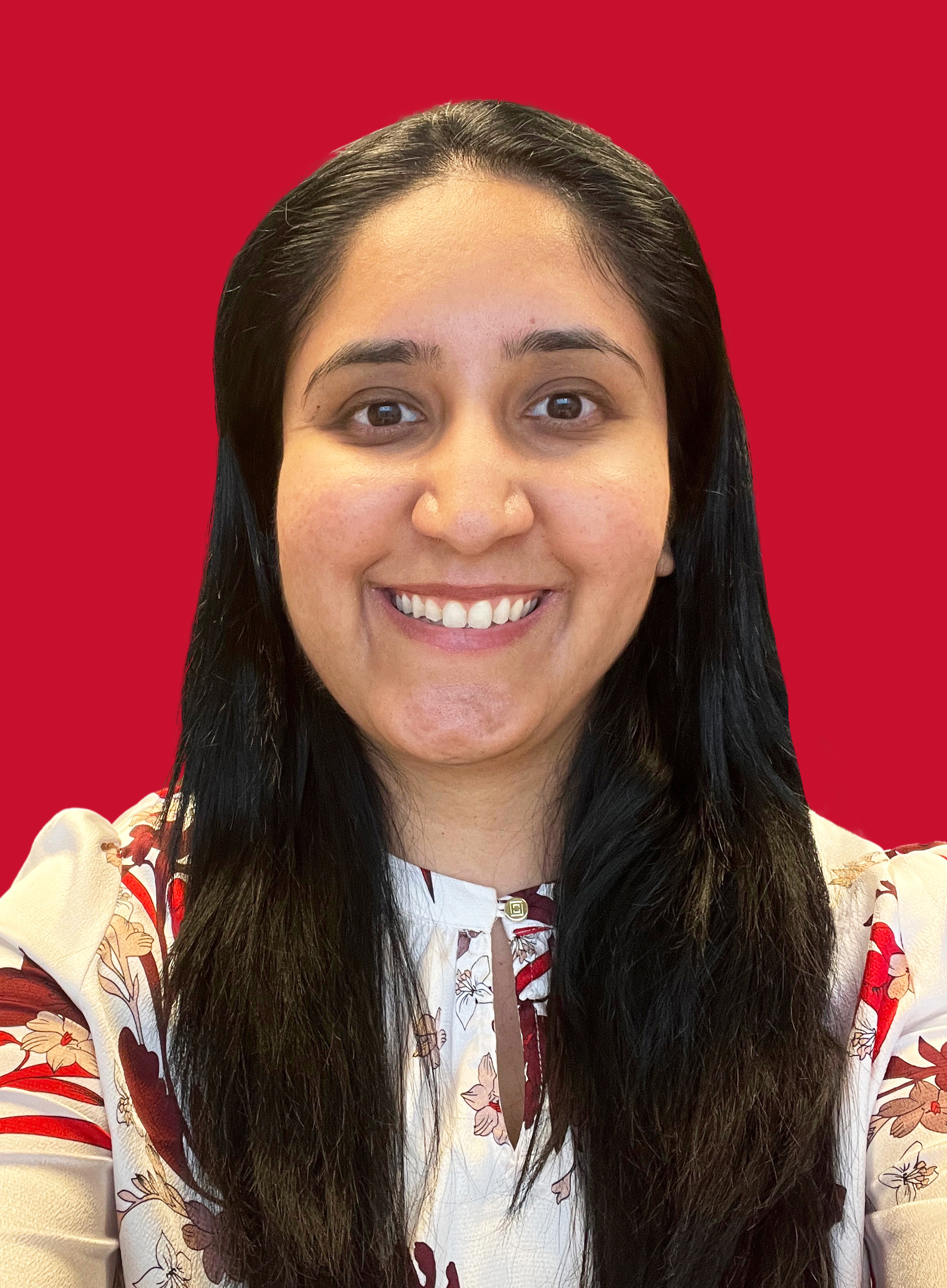 Portrait of Rashi Singh on a red background.